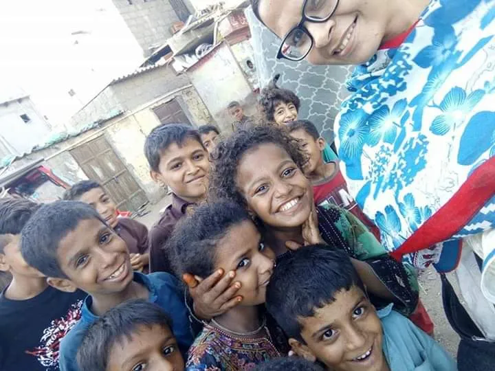 Group of smiling children hugging representing social welfare support program